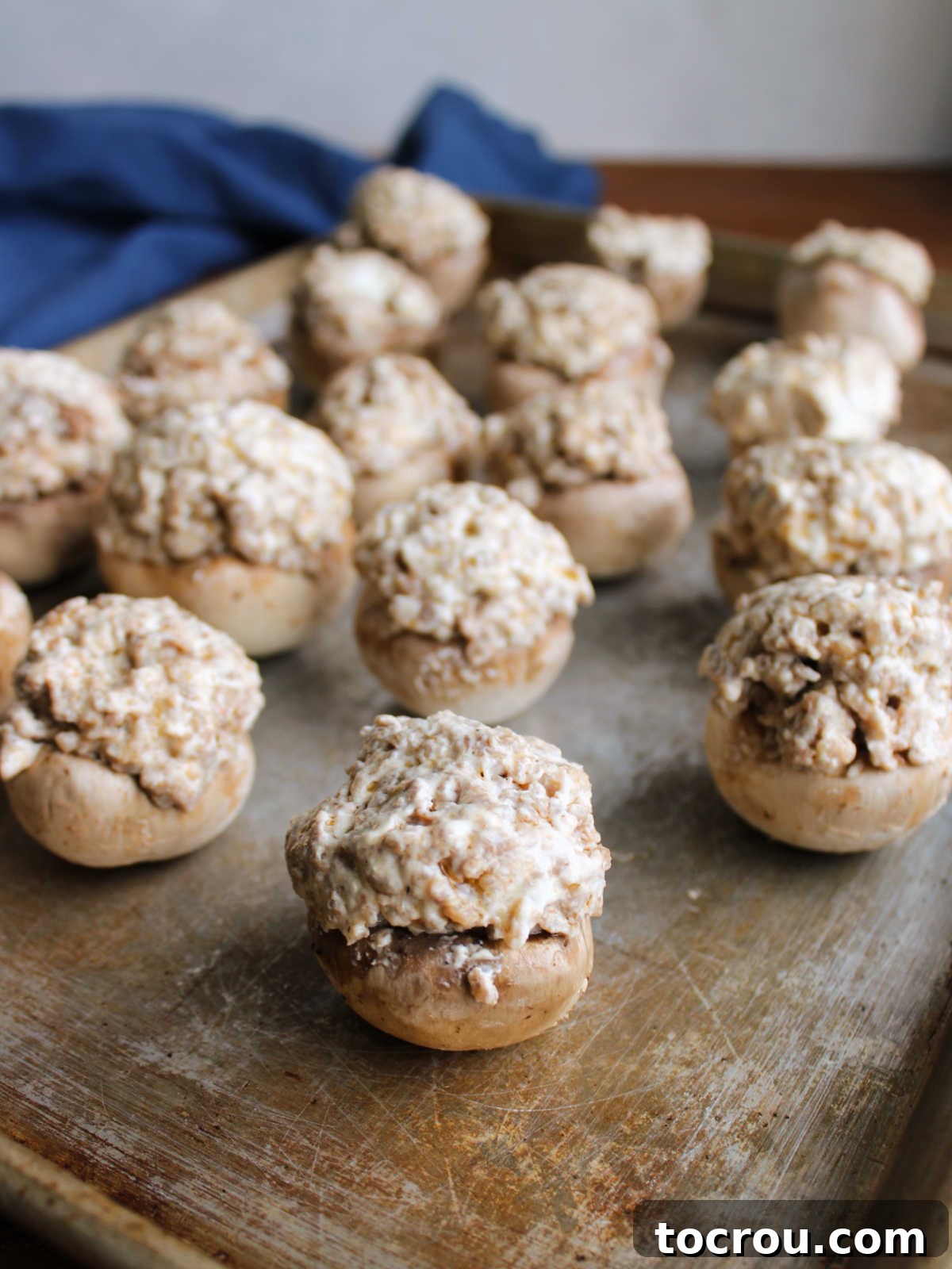 Savory Sausage Stuffed Mushrooms 4 Tray of mushrooms with cream cheese and sausage filling ready to go in the oven.