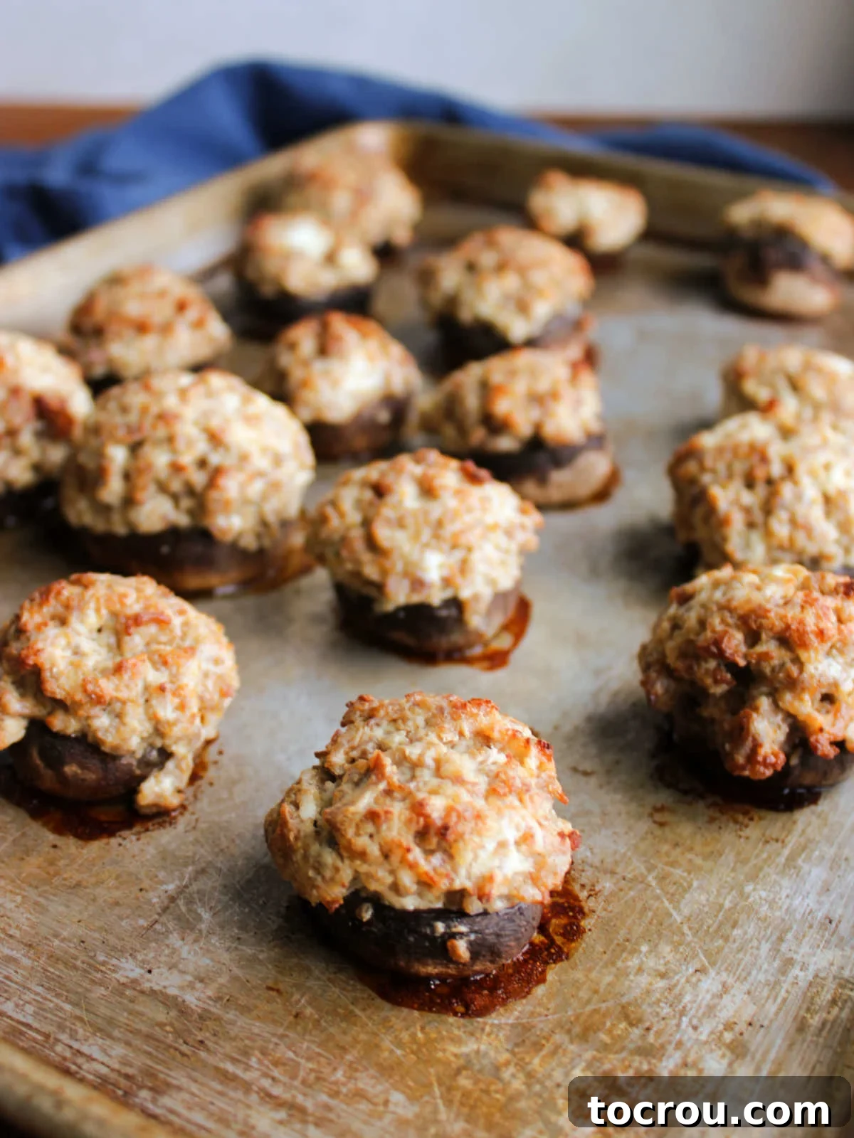 Savory Sausage Stuffed Mushrooms 5 Baked stuffed mushrooms fresh from the oven with golden brown filling.