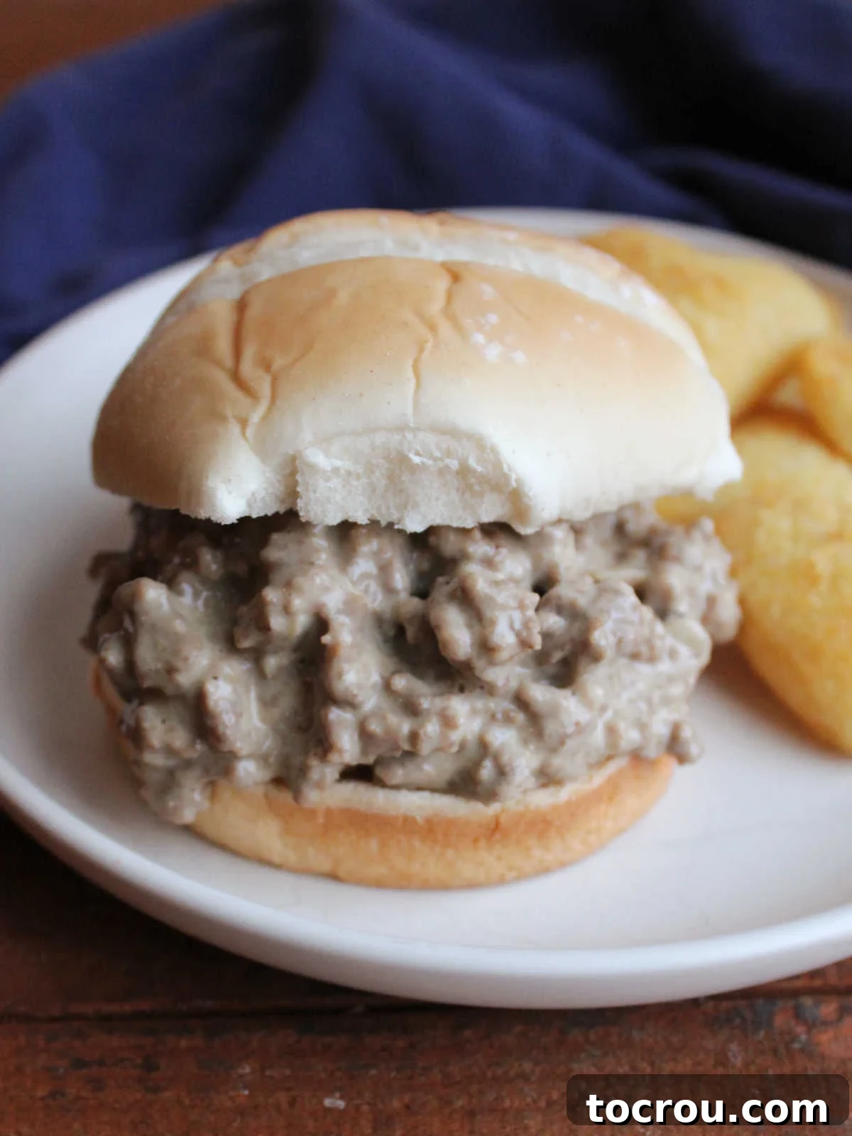 Close-up of a perfectly prepared cheesy ground beef Davy Crockett sandwich filling, generously piled on a soft bun, ready to be enjoyed.