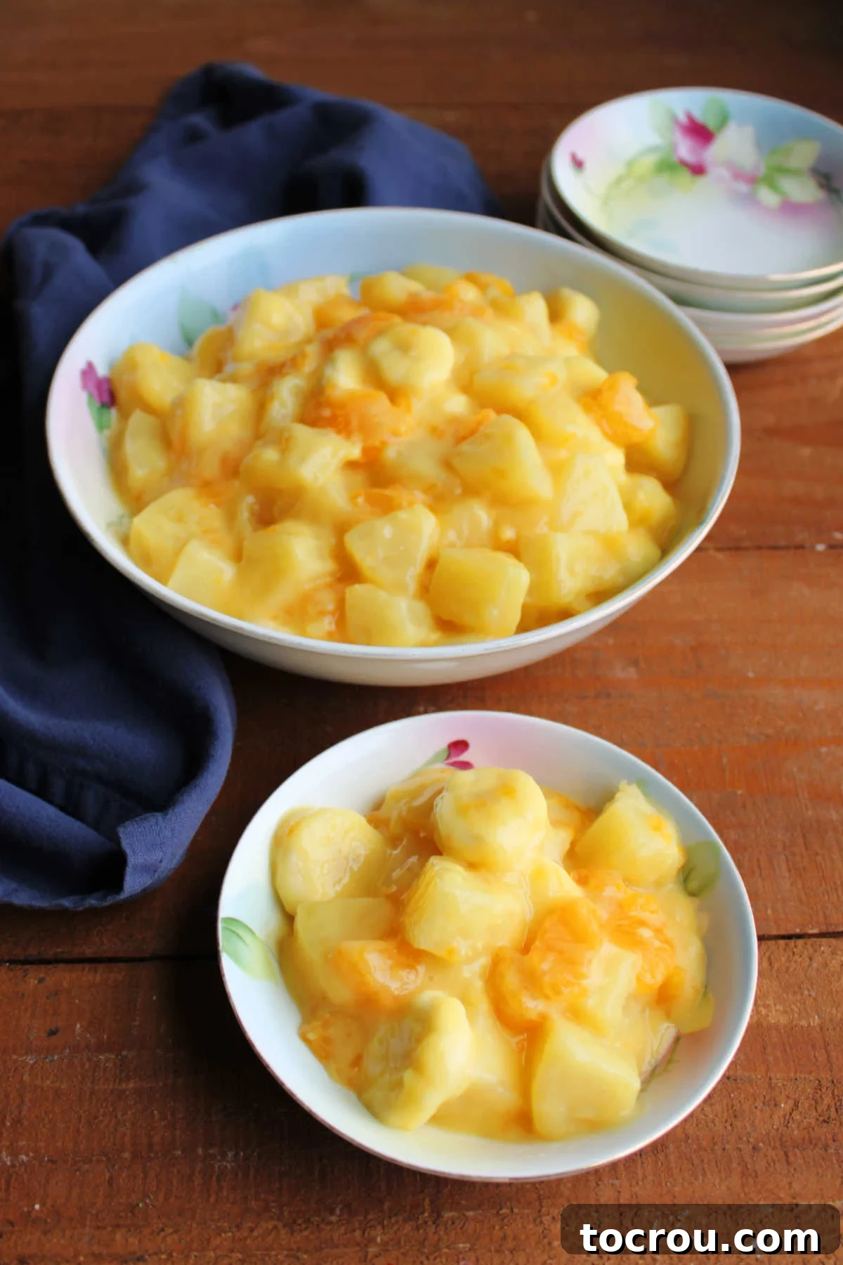 Pineapple, orange, and banana sunshine salad in bowls, ready to eat.