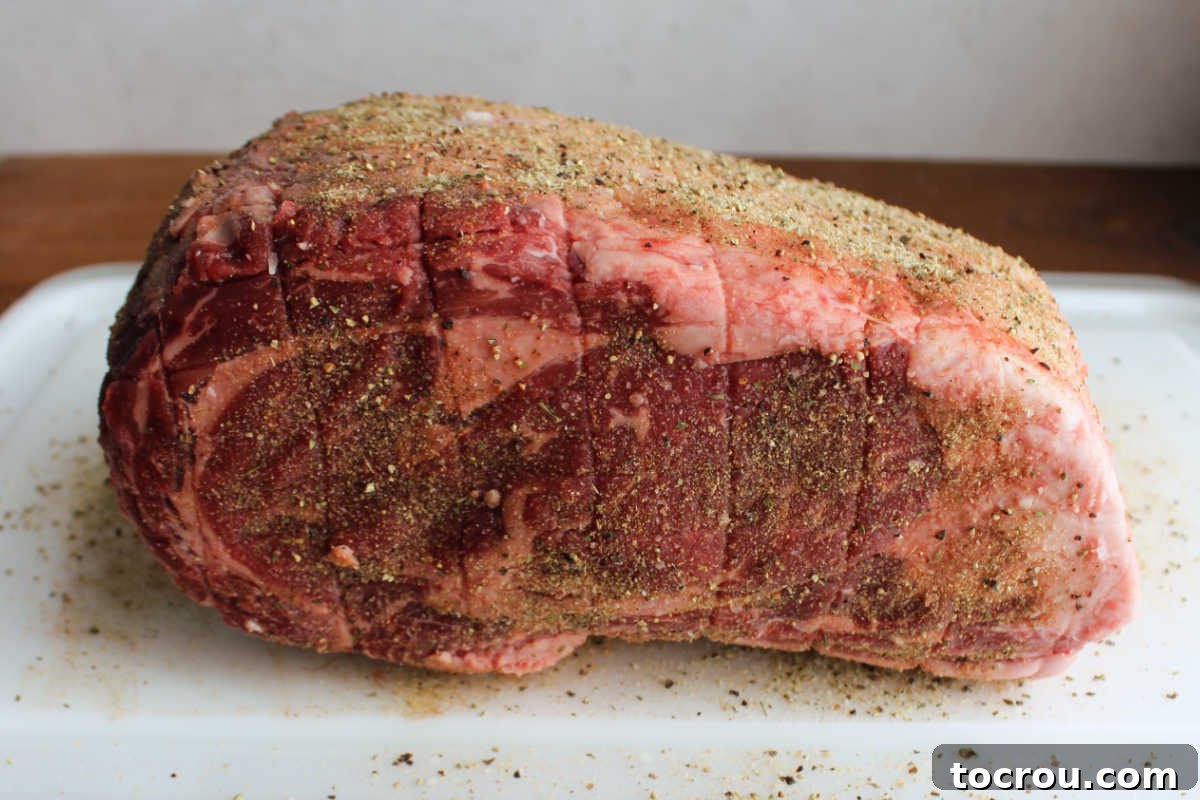 Prime rib coated in seasonings, ready to go on the pellet grill.