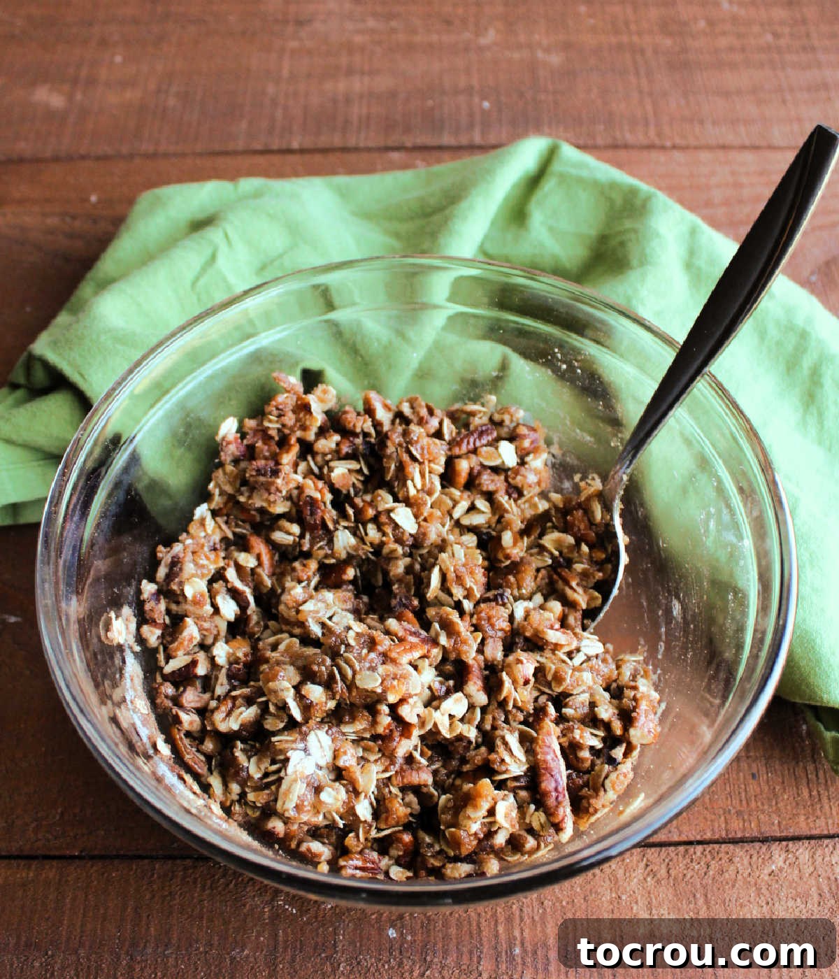 Brown sugar, oatmeal and pecan topping in small bowl ready to go on the sweet potato casserole.