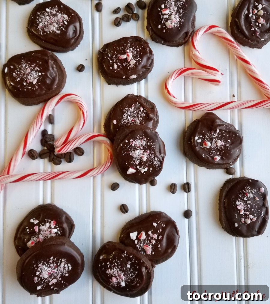 Finished chocolate and peppermint topped mocha shortbread cookies arranged with coffee beans and candy cane hearts.