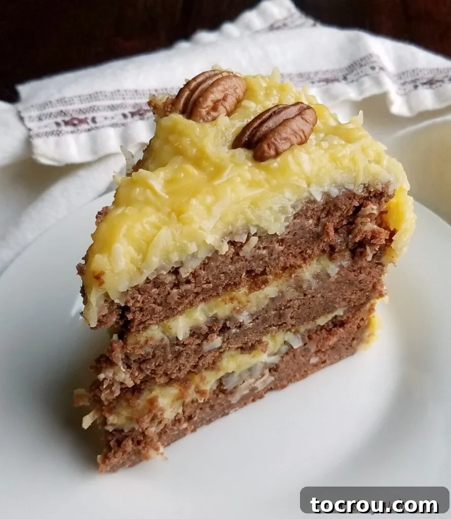 Delicious Slice of German Chocolate Cake with Coconut Frosting Slice of perfectly layered German Chocolate Cake with golden, gooey coconut-pecan frosting, ready to be enjoyed.