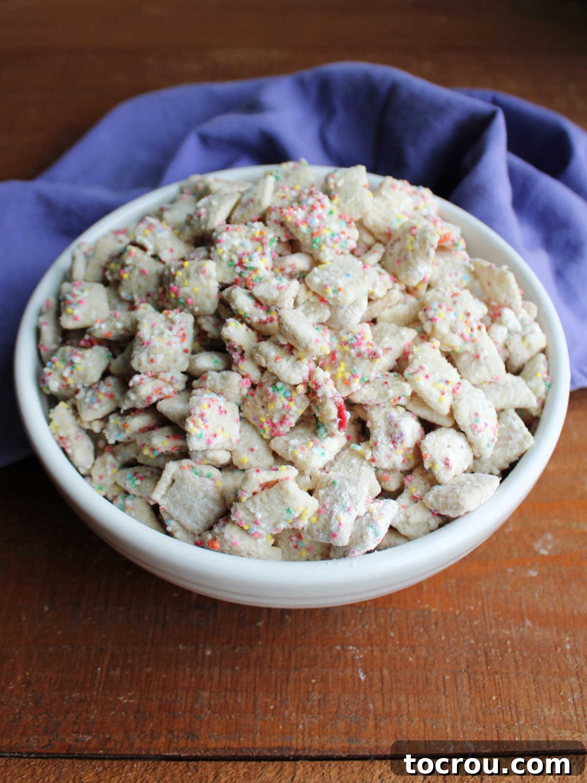 Bowl of funfetti muddy buddies mix, ready to eat. 