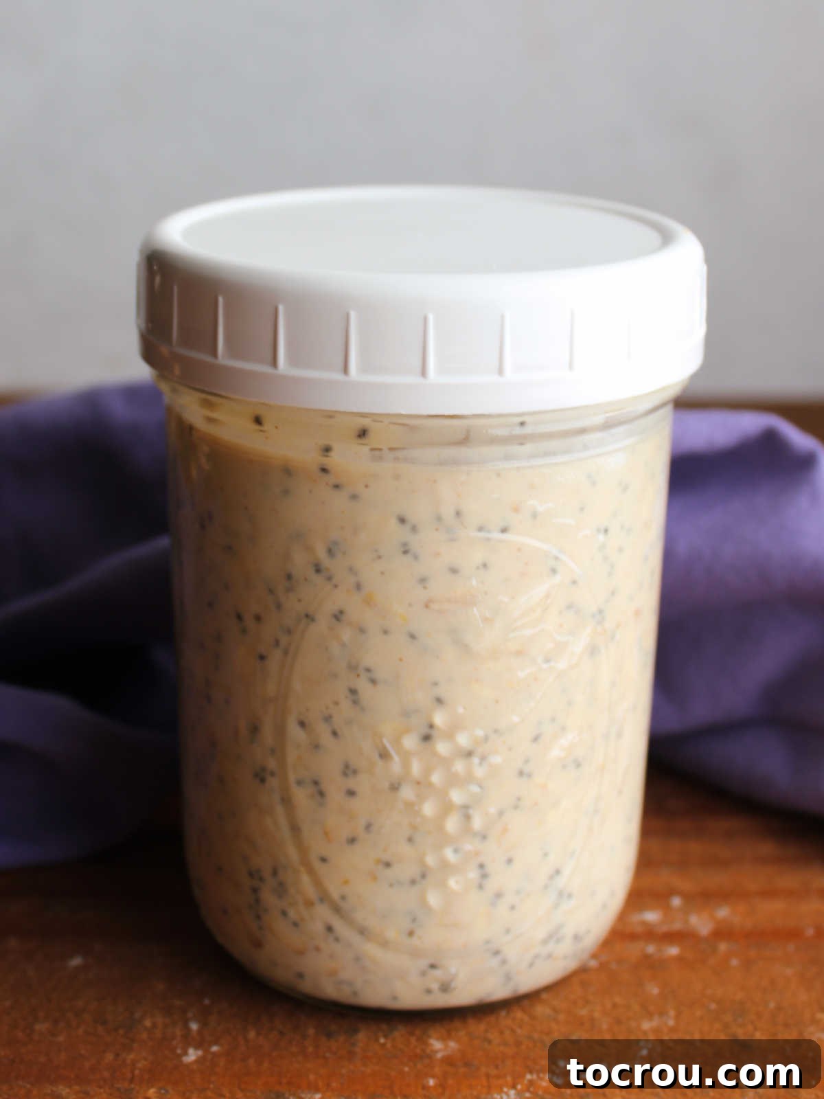 Wide mouth jar filled with peanut butter overnight oats, ready to be enjoyed.
