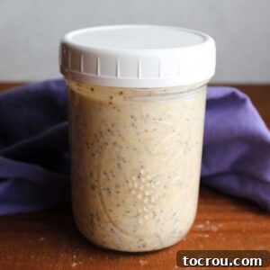 Wide mouth jar filled with peanut butter overnight oats, ready to be enjoyed.