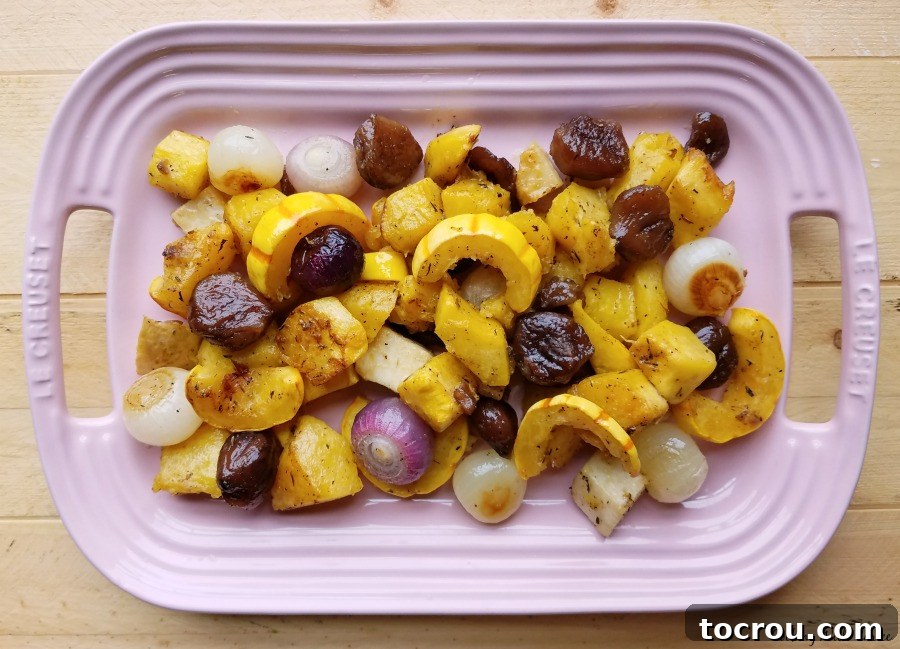 Platter filled with roasted squash, onions and chestnuts glazed with maple syrup and butter.