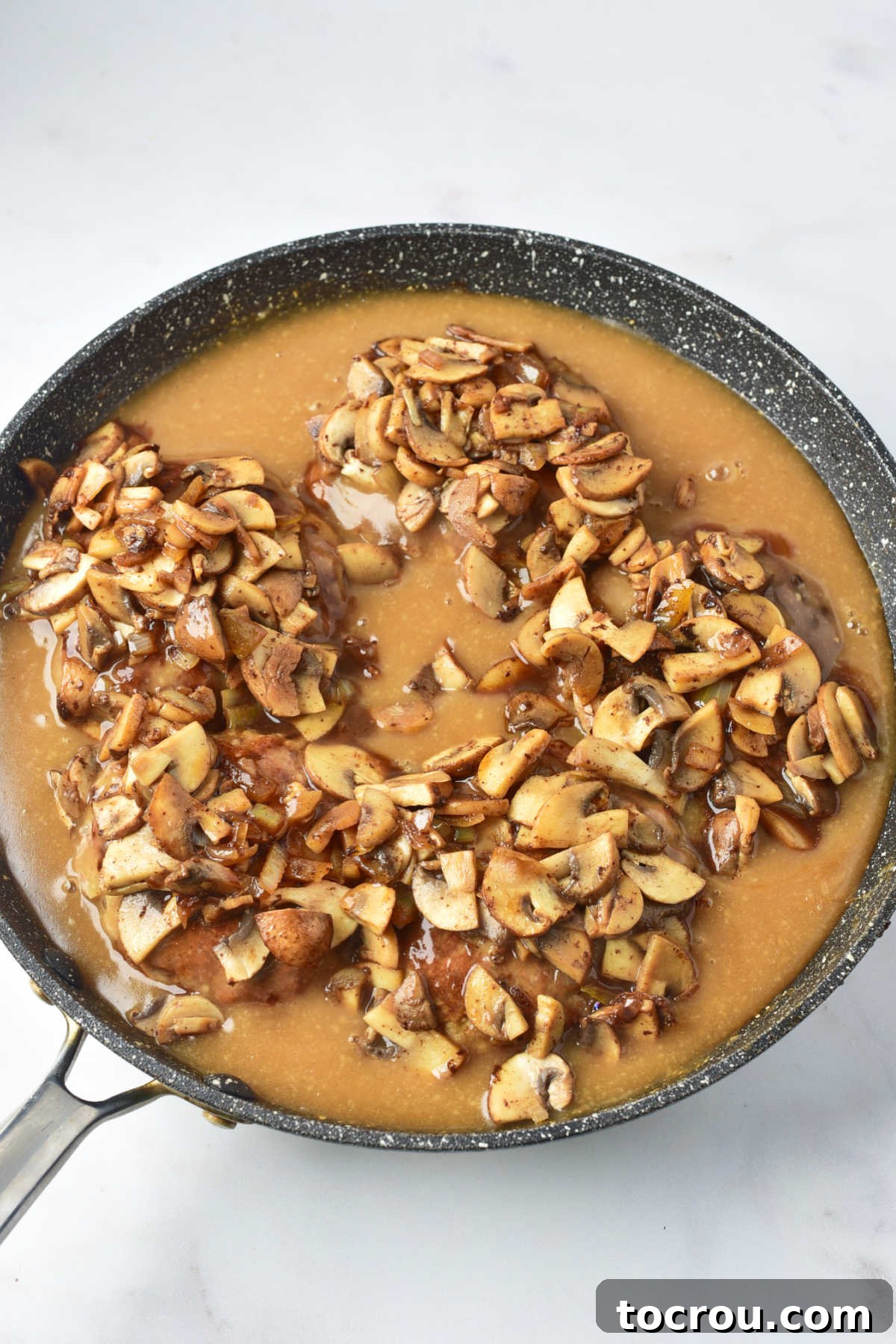 Turkey Salisbury Steaks in Mushroom Gravy Skillet full of turkey salisbury steaks with mushroom gravy, ready to be served.