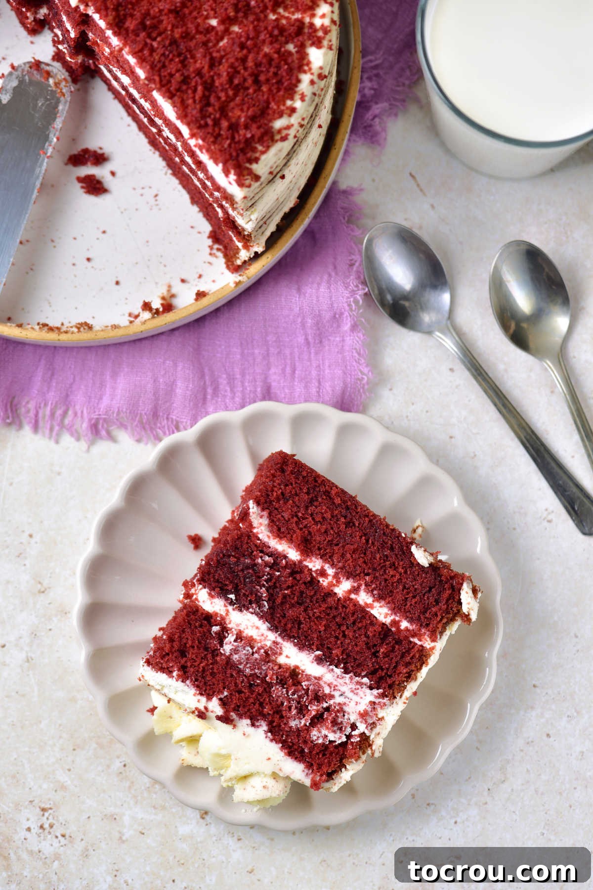 Red Velvet Cake, Served and Ready Served layered red velvet cake with mascarpone frosting next to the cake platter with the remaining cake.