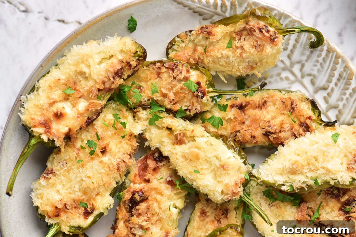 Crispy Air Fryer Jalapeno Poppers Platter of air fryer jalapeno poppers with cheesy bacon filling and crunchy bread crumbs on top.