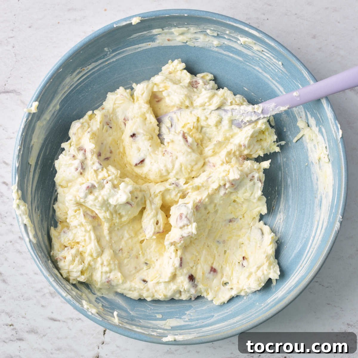 Jalapeno Popper Filling Preparation bowl of cream cheese, white cheddar, and bacon mixture ready to go in jalapenos.