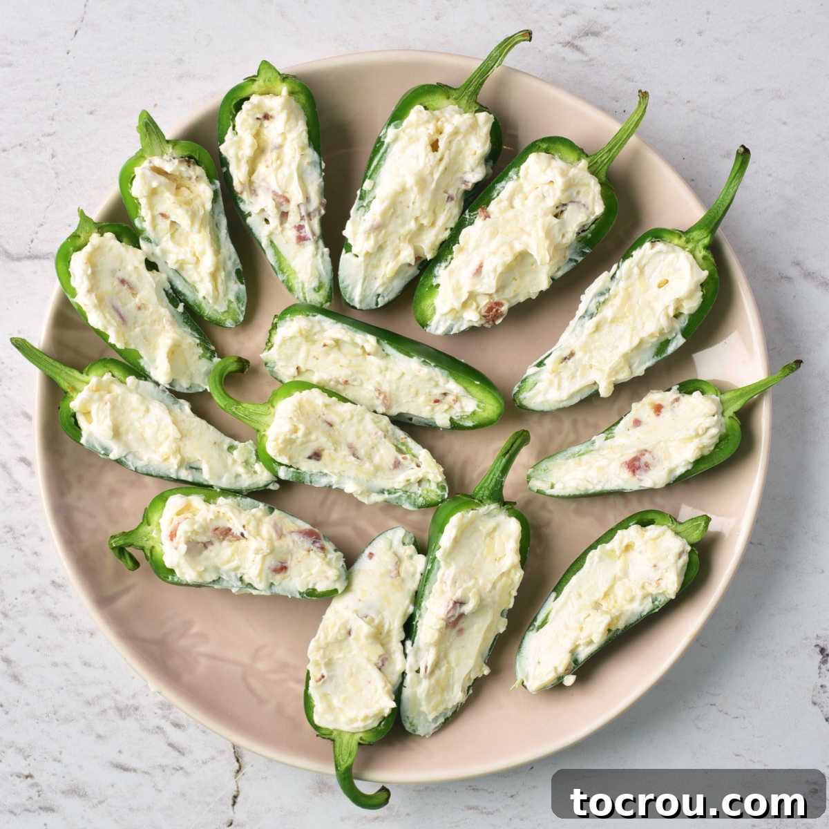 Stuffed Jalapeno Halves Plate of jalapeno halves filled with creamy bacon mixture.