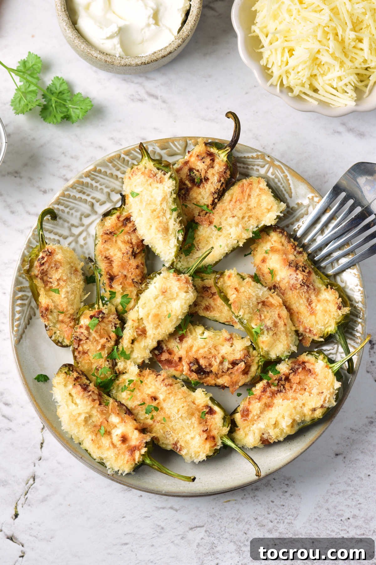 Freshly Air Fried Jalapeno Poppers Plate of air fryer stuffed jalapenos with cheesy bacon filling and golden bread crumb topping.