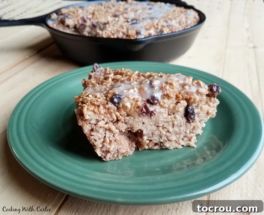 A delicious slice of baked oatmeal studded with plump raisins, ready to be enjoyed as a hearty breakfast.