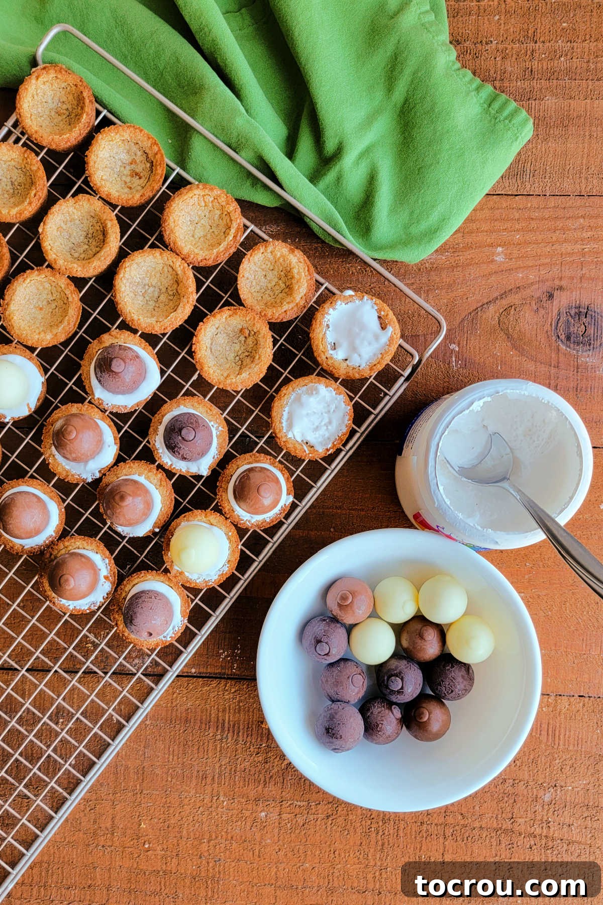 Filling the cooled graham cracker cookies with marshmallow fluff and chocolate truffles. 