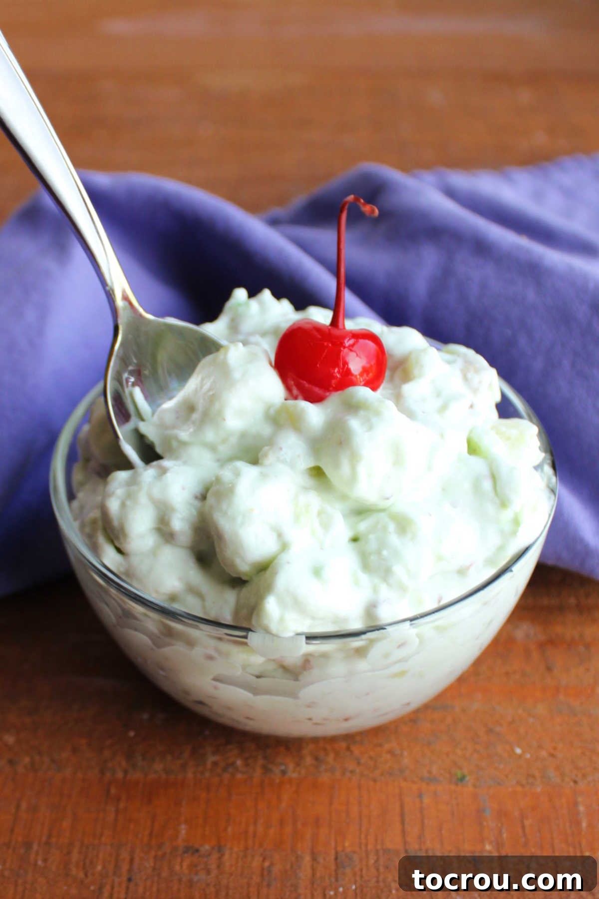 Spoon getting a bite of watergate pistachio fluff. 