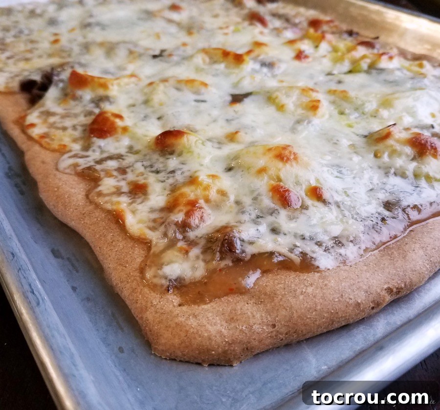corner of freshly baked pizza on sheet pan.