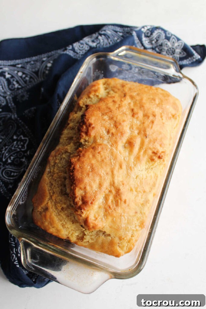 Doris Tangy Cider Loaf 2 Freshly baked loaf of homemade beer bread in glass loaf pan.