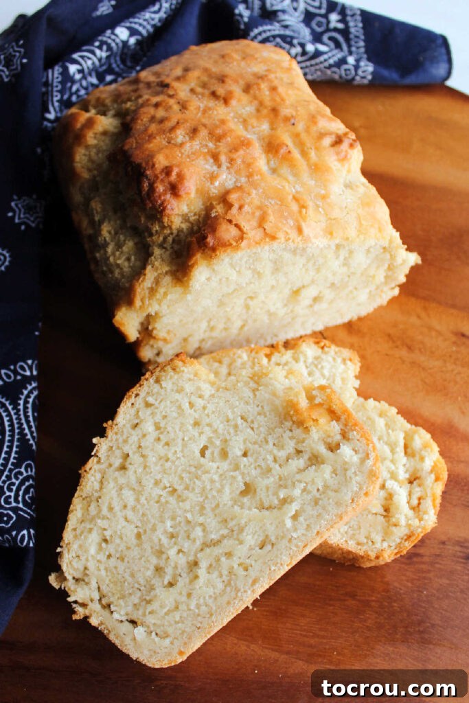 Doris Tangy Cider Loaf 6 Loaf of beer bread with a few slices cut.