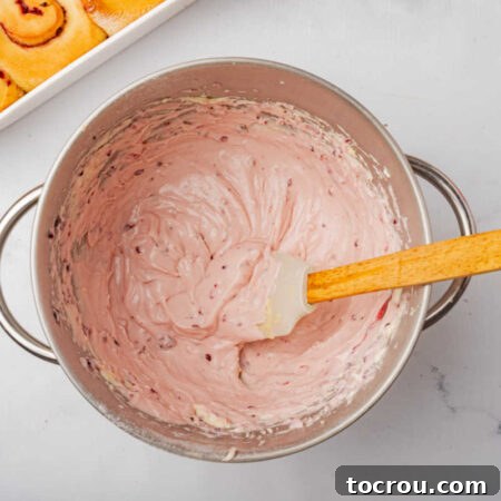 Mixing bowl of blackberry cream cheese frosting.