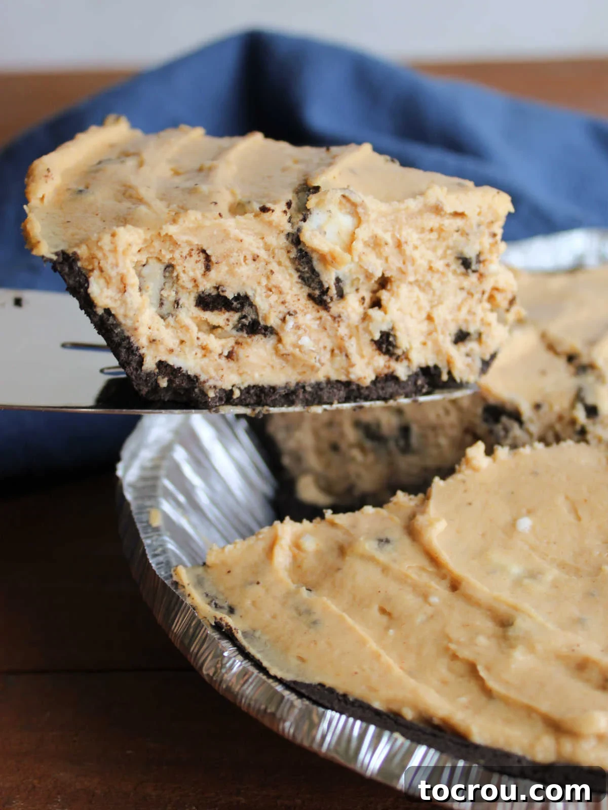 Lifting slice of rock bottom pie from the pan.
