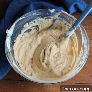 Bowl of peanut butter filling mixture after the whipped topping has been folded in so the mixture is fluffy and light tan.