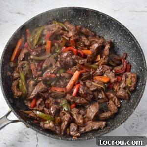 Skillet after venison and sauce have been cooked along with the veggies.