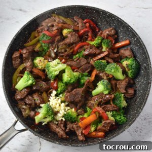 Skillet after broccoli and garlic have been added, ready to be finished.