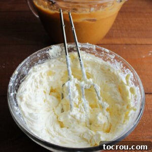 Harvest Pumpkin Bundt Cake with Cream Cheese Core 12 A mixing bowl of whipped cream cheese filling sits next to a bowl of vibrant pumpkin cake batter, ready for assembly.