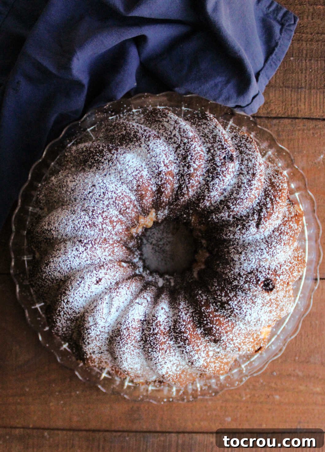 Harvest Pumpkin Bundt Cake with Cream Cheese Core 3 A gorgeous pumpkin Bundt cake, generously dusted with powdered sugar, ready to be served and enjoyed.