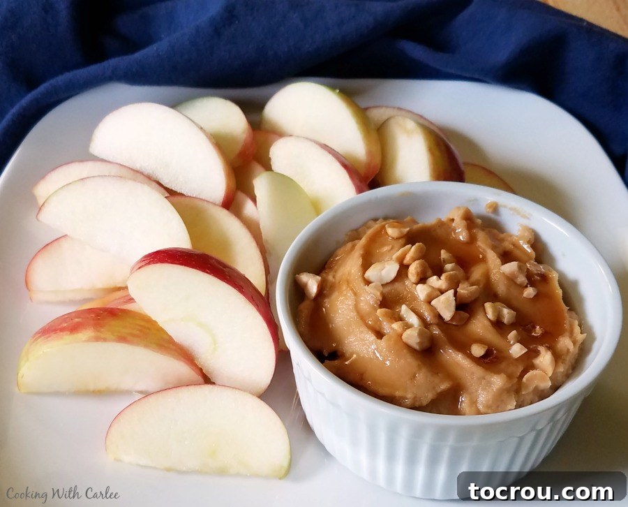 Enjoy this wholesome Peanut Butter Yogurt Dip with a variety of fresh fruits. side view of plate with apples and peanut butter yogurt fruit dip.