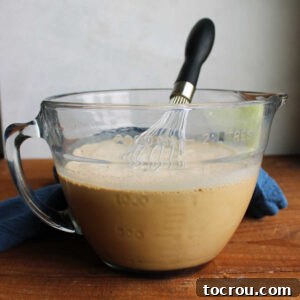 A mixing bowl filled with the prepared homemade coffee ice cream base, showcasing a smooth, creamy texture and ready to be transferred to an ice cream maker for churning.