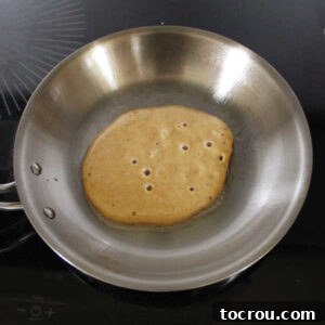 Bubbly pancake, ready to be flipped.