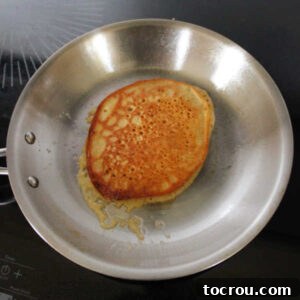 Skillet with golden brown pancake inside.