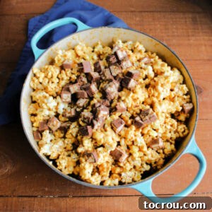 Adding bits of snickers candy bars to baked caramel corn to mix in and melt.