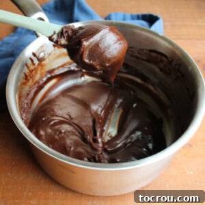 Even thicker cooled chocolate boiled milk mixture, now solid enough to be scooped, indicating proper chilling.