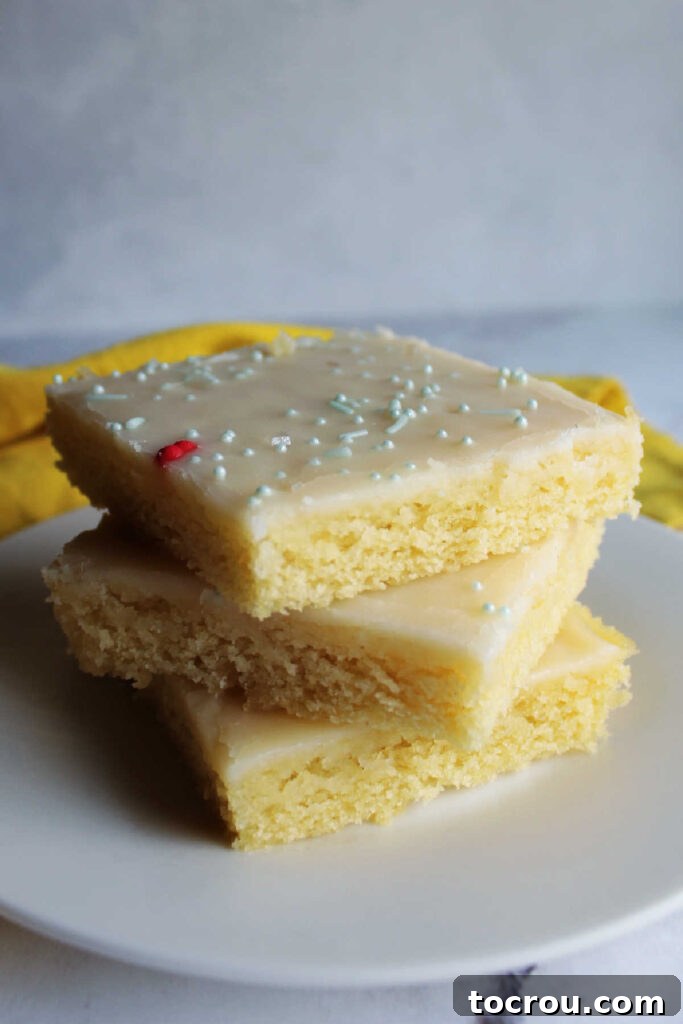 Golden Lemon Crowd Pleaser 7 Square pieces of Lemon sheet cake stacked on top of each other.