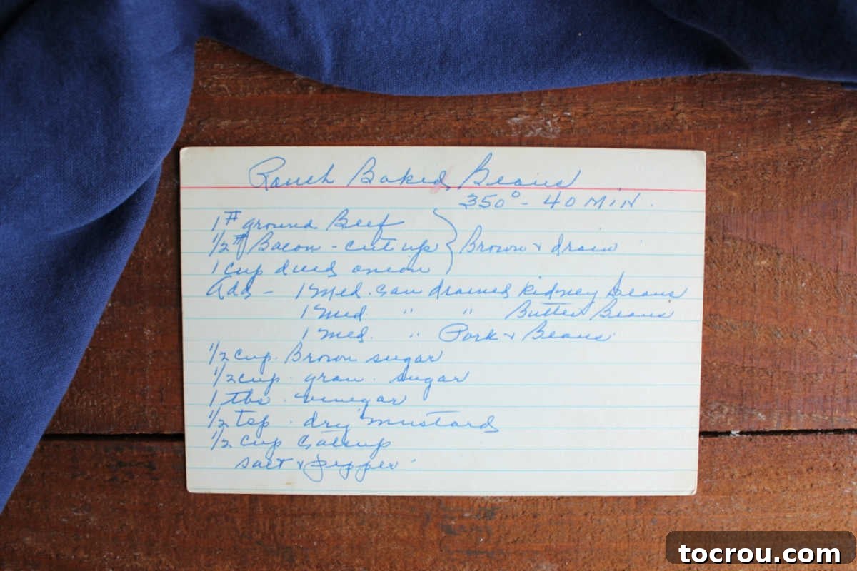 Hand written recipe for ranch baked beans on an index card. 