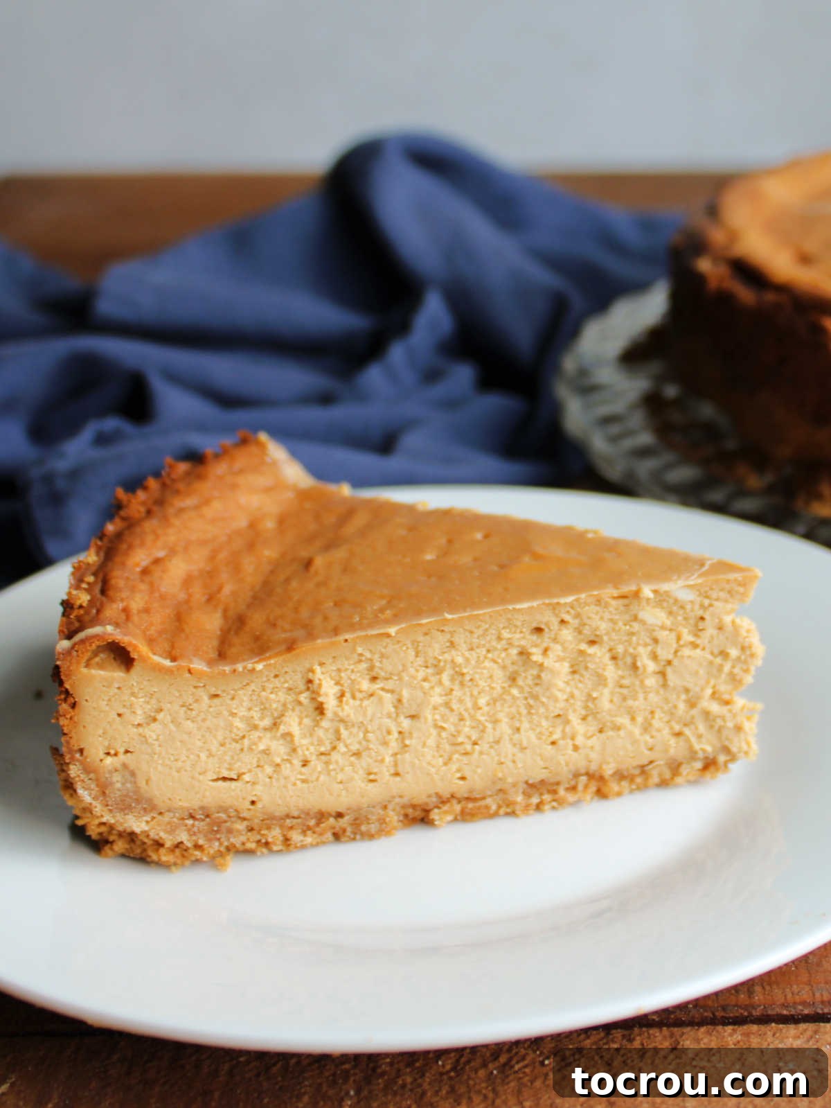 Close up of a slice of caramel flavored dulce de leche cheesecake. 