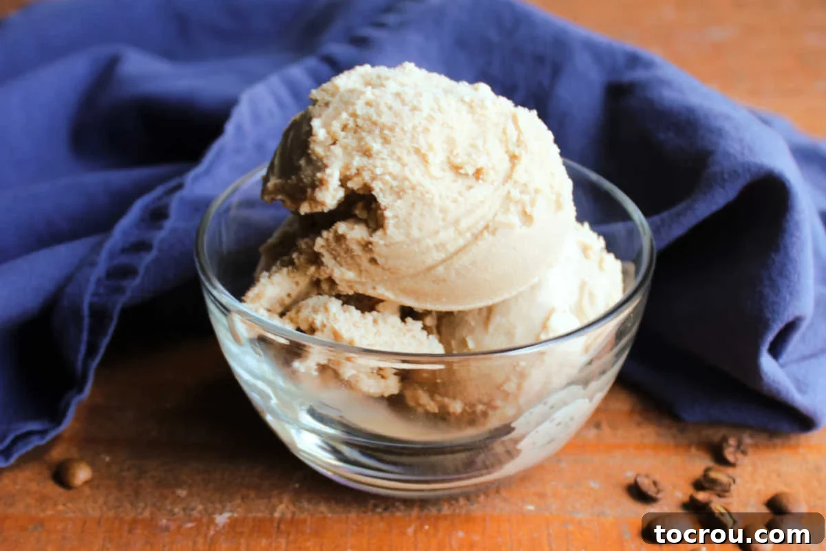 A small glass bowl brimming with luxurious coffee condensed milk ice cream, perfectly ready to be savored. The creamy texture is visibly appealing.