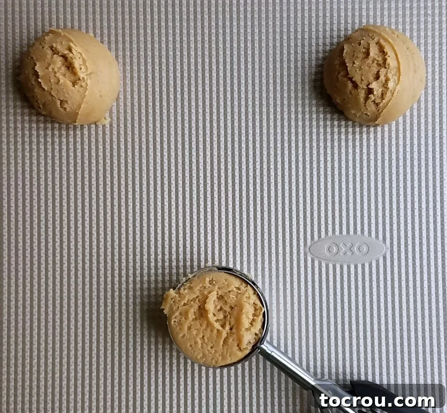 Cookie Dough Scoops scoops of maple cinnamon cookie dough on cookie sheet getting ready to bake.
