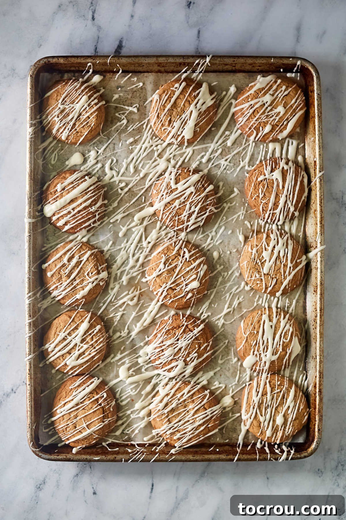 Glazed Maple Cinnamon Cookies Pan of chewy maple cinnamon cookies drizzled with a powdered sugar glaze.