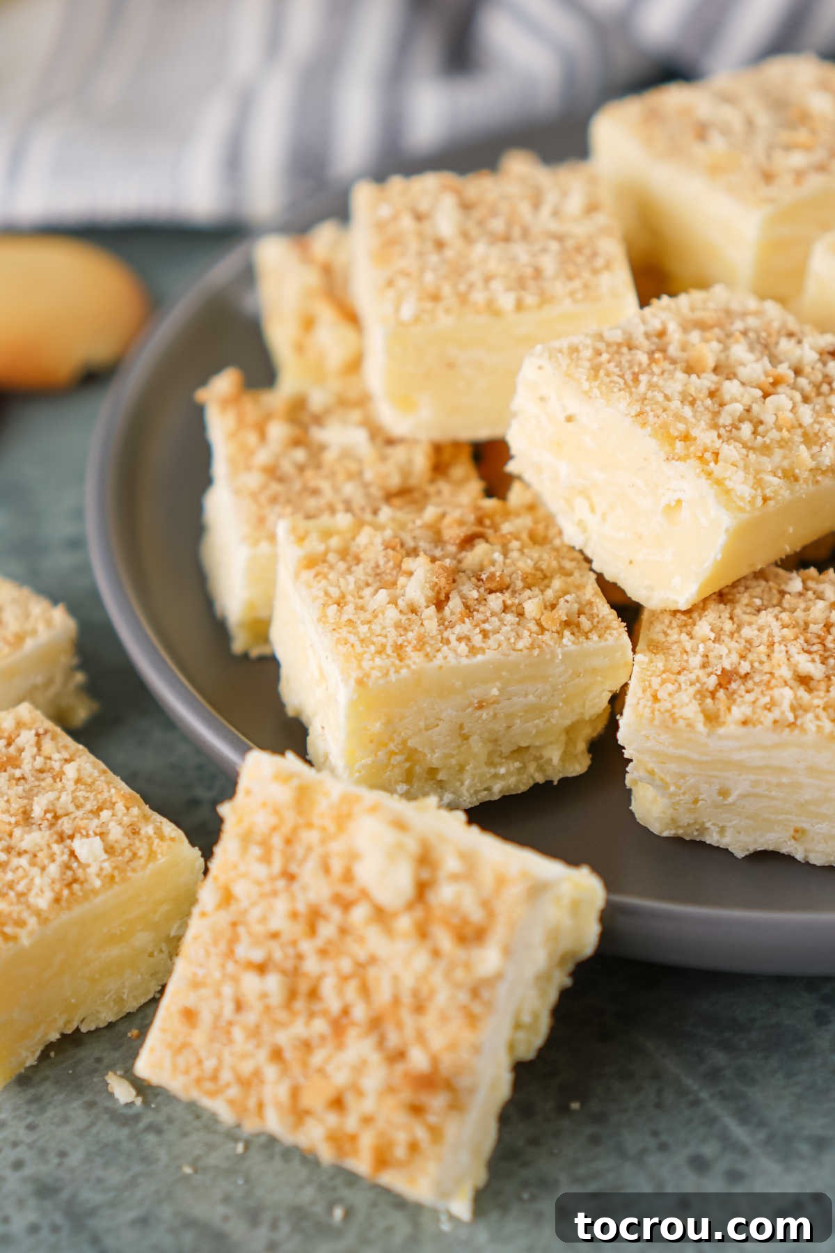 Creamy Banana Fudge with Vanilla Wafers Close up of pieces of banana fudge made from condensed milk, white chocolate, instant pudding, and vanilla wafers.