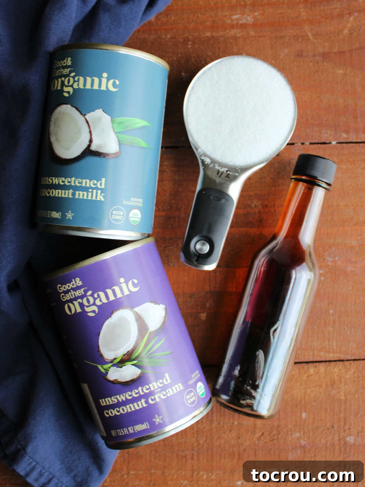 Ingredients including a can of coconut milk, a can of coconut cream, sugar, and vanilla ready to be made into ice cream.