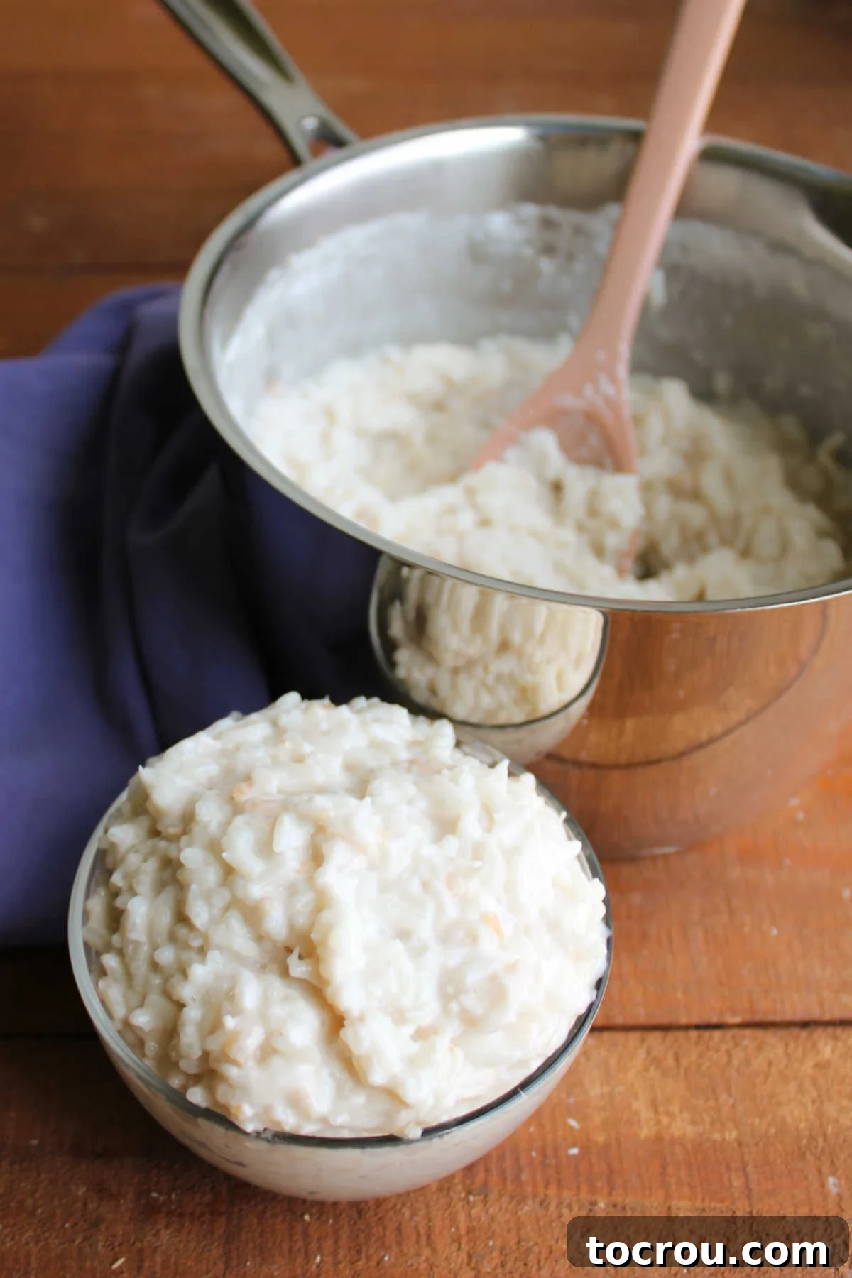 A small bowl brimming with creamy coconut rice pudding is placed beside the saucepan, inviting a delightful taste.