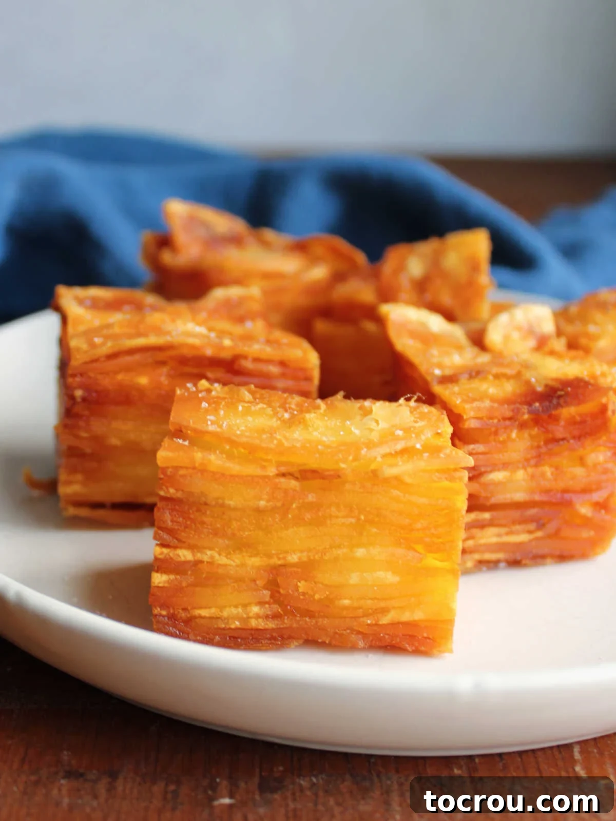 Plate of thousand layer potatoes with layers of thin sliced potato coated in duck fat and fried until crisp.