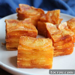 Cubes of thinly sliced potatoes stacked and fried until golden brown with truffle salt on top.