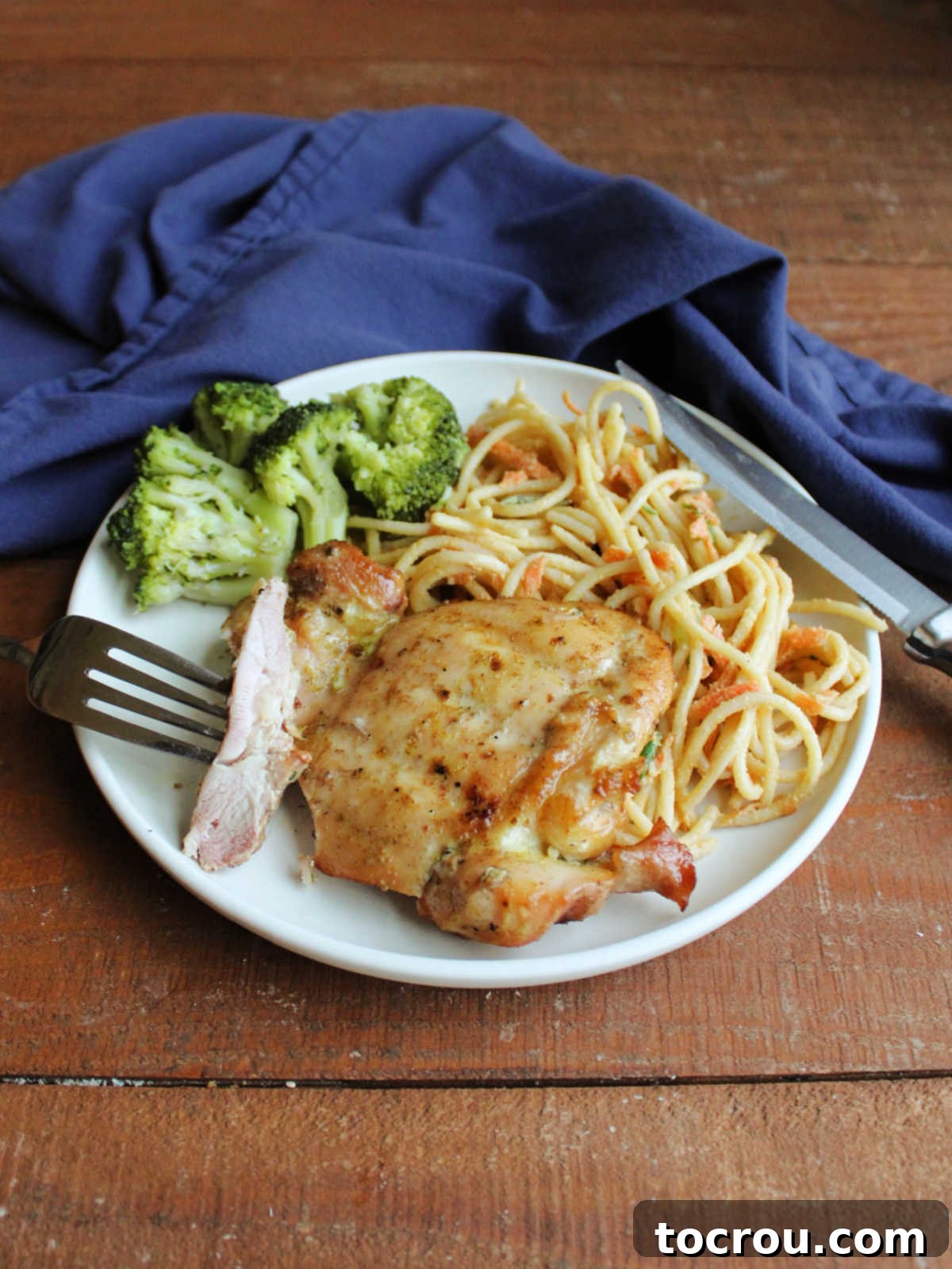 A close-up of a fork holding a piece of coconut lime chicken, revealing its juicy interior and perfectly seasoned exterior, ready to be enjoyed.