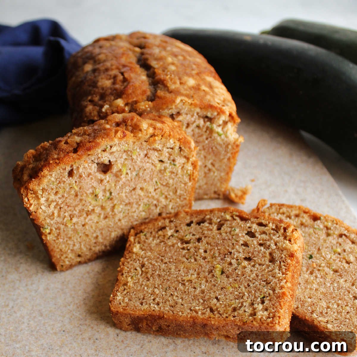 Close up of slices of zucchini bread with cinnamon sprinkle, showcasing a perfect crumb.